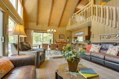 a living room with leather couches and a table at Lake Arrowhead Family Home with Game Room in Lake Arrowhead