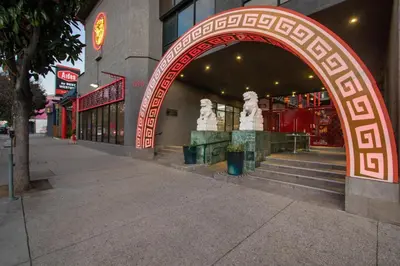 an archway in front of a building with a statue at Aiden Los Angeles Downtown Dragon Gate Inn in Los Angeles