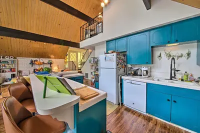 a kitchen with blue cabinets and a white refrigerator at Lake Arrowhead A-Frame House with Private Hot Tub! in Lake Arrowhead