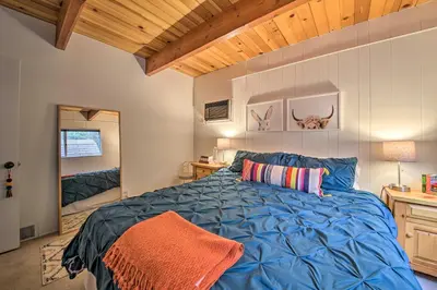 a bedroom with a blue bed in a room at Lake Arrowhead A-Frame House with Private Hot Tub! in Lake Arrowhead