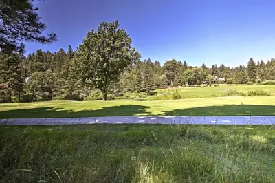 a view of the green at a golf course at Lake Arrowhead A-Frame House with Private Hot Tub! in Lake Arrowhead