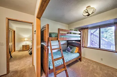 a bedroom with two bunk beds and a ladder at Spacious Lake Arrowhead Home with 2 Decks and Views in Lake Arrowhead
