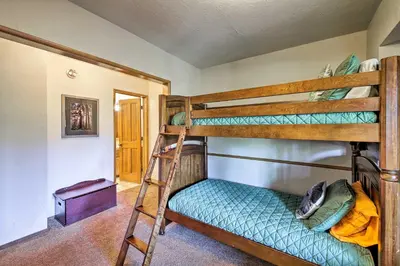 a room with two bunk beds and a ladder at Spacious Lake Arrowhead Home with 2 Decks and Views in Lake Arrowhead