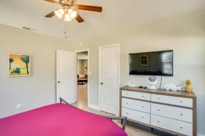 a bedroom with a bed and a flat screen tv at Fullerton Vacation Rental with Private Pool! in Fullerton