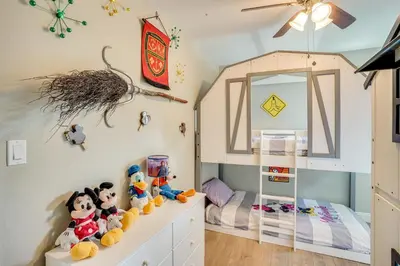 a childs bedroom with a bed and a doll house at Fullerton Vacation Rental with Private Pool! in Fullerton