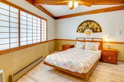 a bedroom with a bed and two windows at Star House Unique Home with 360 Mountain Views! in Pine Mountain Club