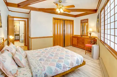 a bedroom with a bed and a desk and a ceiling fan at Star House Unique Home with 360 Mountain Views! in Pine Mountain Club