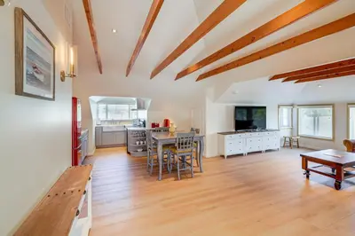 a living room with a table and a kitchen at Victorian Carpinteria Apartment Less Than 1 Mi to Beach! in Carpinteria