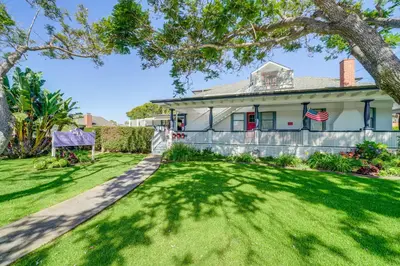 a house with a lawn and a fence at Victorian Carpinteria Apartment Less Than 1 Mi to Beach! in Carpinteria