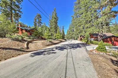 an empty road in front of a house at Big Bear Lake Cabin with Deck about 7 Mi to Ski Slopes! in Fawnskin