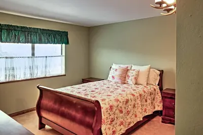 a bedroom with a bed and a window at Lake Arrowhead House with Lake Views and Wet Bar! in Lake Arrowhead