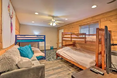 a living room with two bunk beds and a couch at A-Frame Home with 3 Decks and Lake Arrowhead Views! in Lake Arrowhead