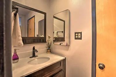 a bathroom with a sink and two mirrors at A-Frame Home with 3 Decks and Lake Arrowhead Views! in Lake Arrowhead