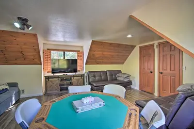a living room with a ping pong table at Lake Arrowhead Family Home with Deck! in Lake Arrowhead