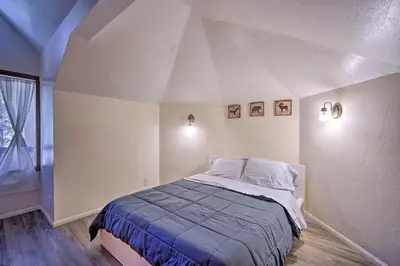 a bedroom with a large bed in a attic at Lake Arrowhead Family Home with Deck! in Lake Arrowhead