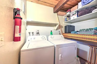 a laundry room with a washer and a fire extinguisher at Cabin with Mtn Views and Deck, 5 Min To Arrowbear Lake! in Arrowbear Lake