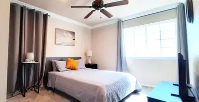 a bedroom with a bed and a ceiling fan at GREAT FOR BUSINESS & FAMILY TRIPS 3BD 2BA close to DESNEYLAND, FREE PARKING in Orange