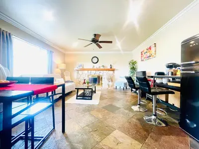 a living room with a table and some chairs at GREAT FOR BUSINESS & FAMILY TRIPS 3BD 2BA close to DESNEYLAND, FREE PARKING in Orange