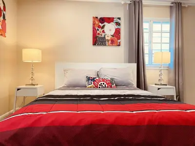 a bedroom with a large bed with two lamps at GREAT FOR BUSINESS & FAMILY TRIPS 3BD 2BA close to DESNEYLAND, FREE PARKING in Orange