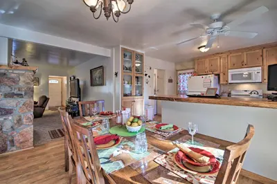 a kitchen and dining room with a table and chairs at Walk to Lake Rustic Home with Deck in Fawnskin in Fawnskin