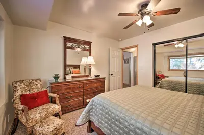 a bedroom with a bed and a ceiling fan at Walk to Lake Rustic Home with Deck in Fawnskin in Fawnskin