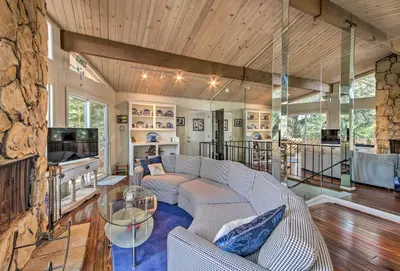 a living room with a couch and a fireplace at Lake Arrowhead Cabin with Deck and Scenic Forest Views in Lake Arrowhead