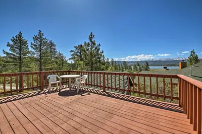 a wooden deck with a table and two chairs on it at Walk to Lake Cabin with Deck and Views in Fawnskin in Fawnskin