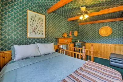 a bedroom with a bed and a ceiling fan at Walk to Lake Cabin with Deck and Views in Fawnskin in Fawnskin