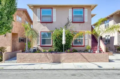 a house with a garden in front of it at New Beach Jewel Bungalow in Long Beach