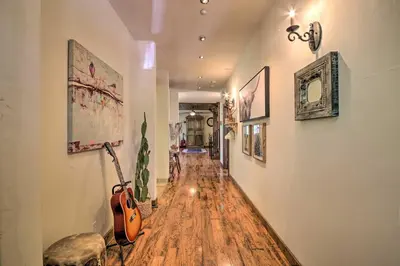 a hallway with a hard wood floor and a guitar at Incredible Lake Arrowhead Home with Views and Decks! in Lake Arrowhead