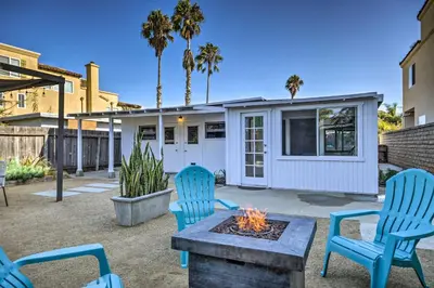 a backyard with a fire pit and chairs and a house at Remodeled Ventura Beach Home with Yard and Fire Pit! in Ventura