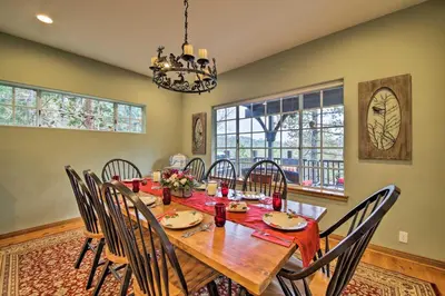 a dining room with a wooden table and chairs at Luxe Lake Arrowhead Home with Deck, 3 Mi to Village! in Lake Arrowhead