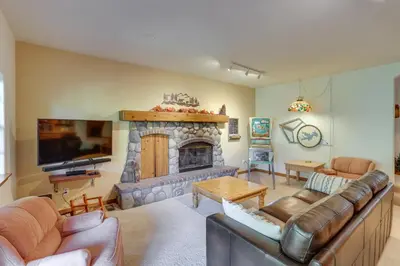 a living room with a couch and a fireplace at Luxe Lake Arrowhead Home with Deck, 3 Mi to Village! in Lake Arrowhead