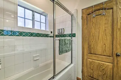 a bathroom with a shower and a glass door at Luxe Lake Arrowhead Home with Deck, 3 Mi to Village! in Lake Arrowhead