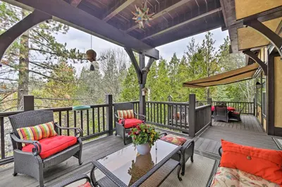 a patio with chairs and a table on a deck at Luxe Lake Arrowhead Home with Deck, 3 Mi to Village! in Lake Arrowhead