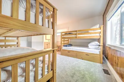 a bedroom with two bunk beds and a window at Gorgeous Lake Arrowhead Retreat Game Room and Deck in Lake Arrowhead