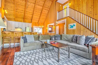 a living room with a couch and a table at Gorgeous Lake Arrowhead Retreat Game Room and Deck in Lake Arrowhead