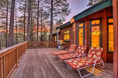 a deck with two chairs and a house at Hike, Ski, Fish Big Bear Lake Lodge with Deck in Big Bear Lake