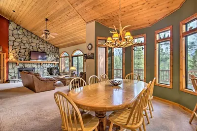 a dining room with a wooden table and chairs at Hike, Ski, Fish Big Bear Lake Lodge with Deck in Big Bear Lake