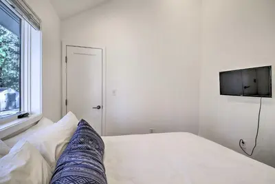 a bedroom with a bed with a tv on the wall at Half-Mi to Big Bear Lake Modern Home with Deck in Big Bear Lake