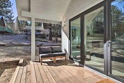 a chair sitting on a deck next to a house at Half-Mi to Big Bear Lake Modern Home with Deck in Big Bear Lake
