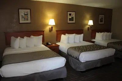 a hotel room with two beds and two lamps at Cajon Pass Inn in Cajon Junction