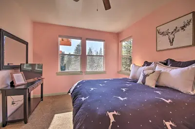 a bedroom with a bed and a desk and windows at Sugar Bear Lodge with Game Room - 5 Mi to Village! in Lake Arrowhead