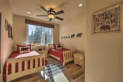 a nursery with two beds and a ceiling fan at Sugar Bear Lodge with Game Room - 5 Mi to Village! in Lake Arrowhead