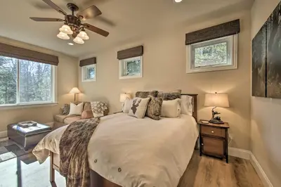 a bedroom with a bed and a ceiling fan at Sugar Bear Lodge with Game Room - 5 Mi to Village! in Lake Arrowhead
