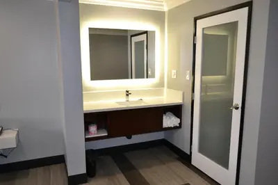 a bathroom with a sink and a mirror at Bell Gardens Inn Los Angeles - Bell Gardens in Bell Gardens