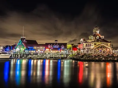 a group of buildings on the water at night at Parkside Inn in Long Beach