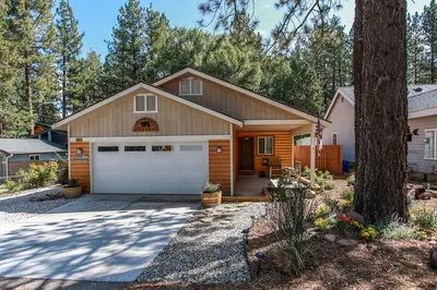 a house with a garage and a tree at Kitkats Hideaway-1874 by Big Bear Vacations in Big Bear Lake
