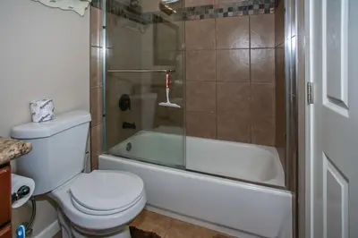 a bathroom with a shower and a toilet and a tub at Kitkats Hideaway-1874 by Big Bear Vacations in Big Bear Lake