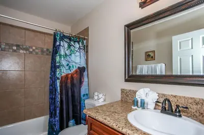 a bathroom with a sink and a toilet and a mirror at Kitkats Hideaway-1874 by Big Bear Vacations in Big Bear Lake
